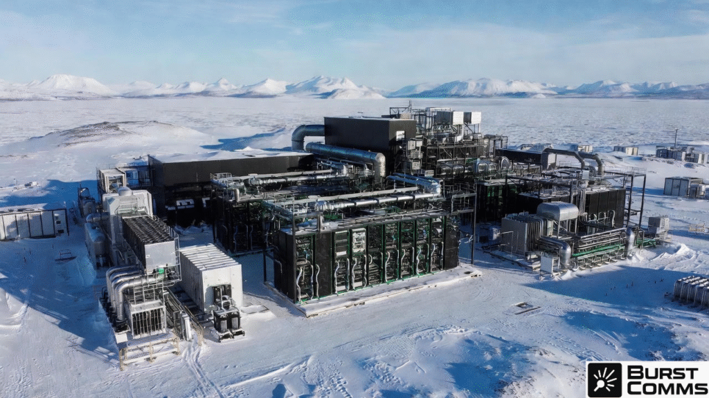 Aerial view of a massive nuclear-powered doomsday data center complex buried in Arctic snow, surrounded by melting permafrost and remote mountain peaks, 2025